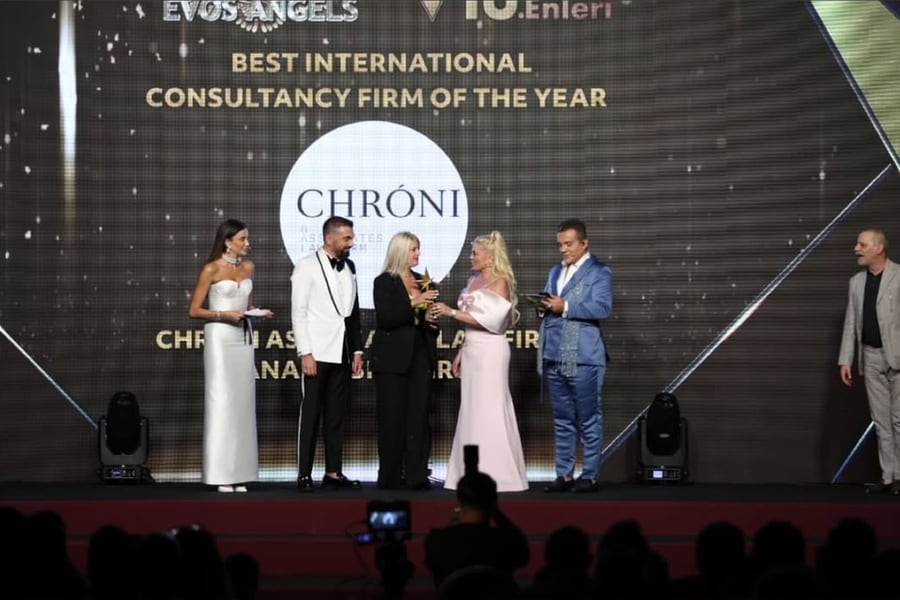 Chroni & Associates receiving the Best International Consultancy Firm of the Year award on stage at the 15th EVOS Angels Awards